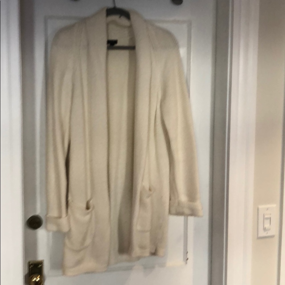 Long cable knit cardigan sweater.